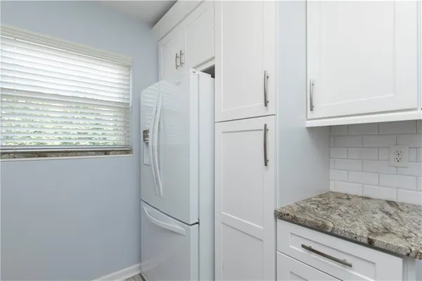 a view of a kitchen cabinets and window