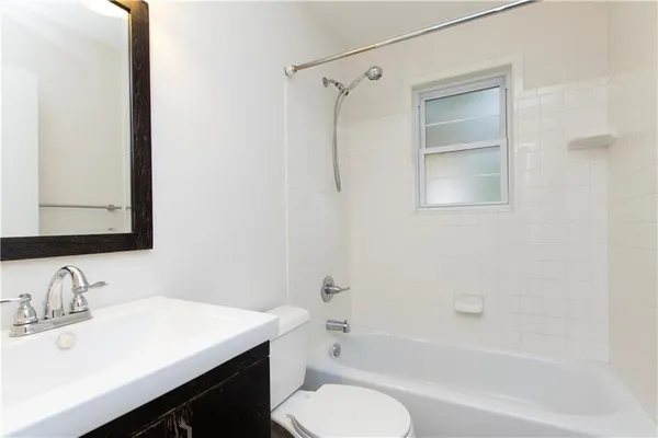 a bathroom with a sink toilet tub and shower
