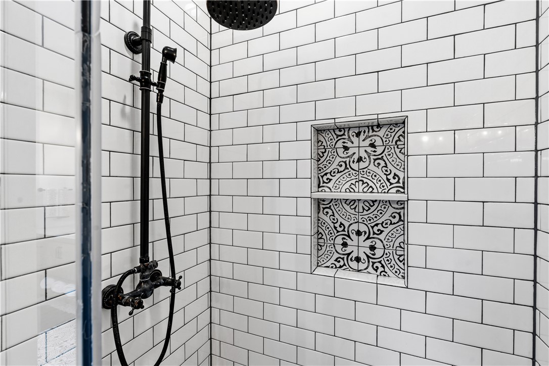 1158 Pyle Road Clarksville, OH 45113 - Photo 33 of 76 This modern shower features subway tile and a decorative tile niche for storage.