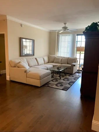 a living room with furniture window and wooden floor