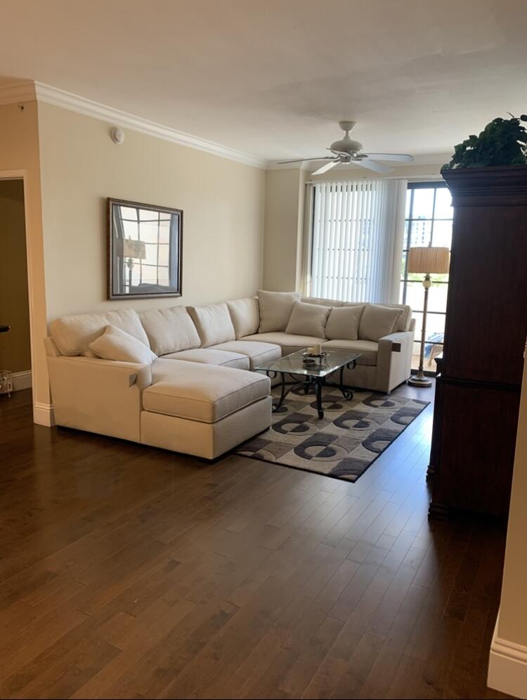 a living room with furniture window and wooden floor