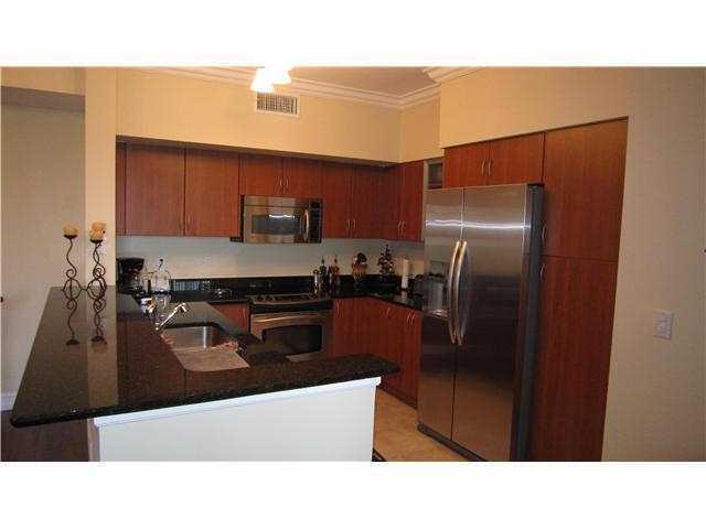 233 South Federal Highway, Unit 321 Boca Raton, FL 33432 - Photo 4 of 40 a kitchen with stainless steel appliances kitchen island granite countertop a refrigerator a stove and a sink