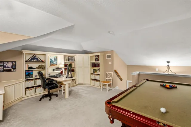 a room with pool table and flat screen tv