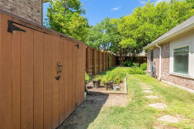 a view of yard with swimming pool and green space