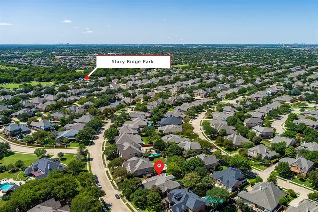 an aerial view of residential houses with outdoor space and street view