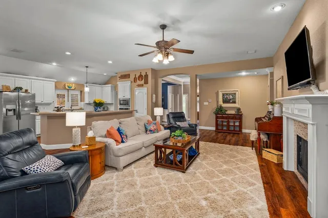 a living room with fireplace furniture and a flat screen tv