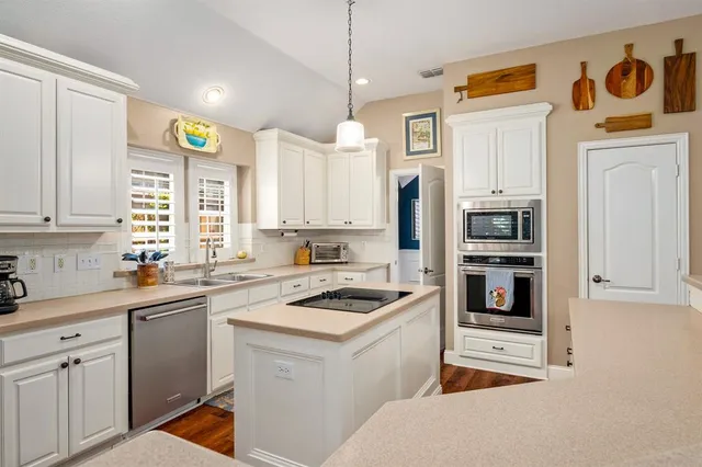 a kitchen with a sink stove and refrigerator