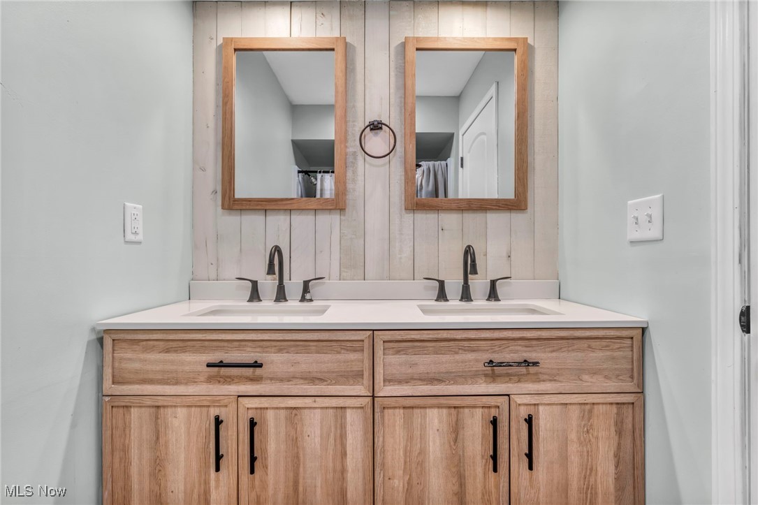 5306 Lockwood Road Madison, OH 44057 - Photo 14 of 28 Bathroom with wooden walls and vanity
