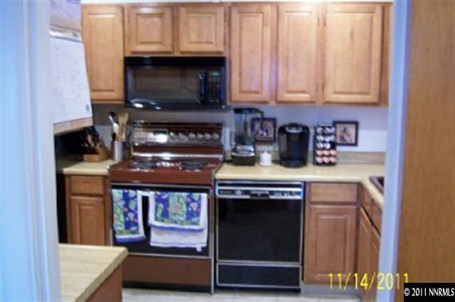 40 Butte Place Reno, NV 89503 - Photo 5 of 13 a kitchen with stainless steel appliances a stove a microwave and cabinets