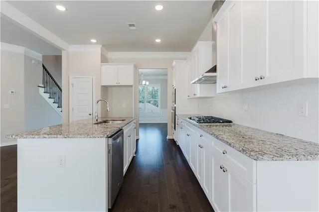 a open kitchen with granite countertop a sink and cabinets