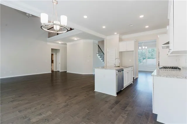 a view of a kitchen with a sink stainless steel appliances and cabinets