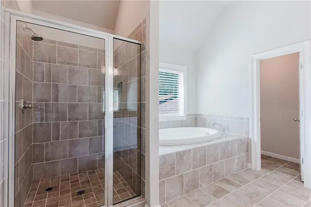 a bathroom with a shower and a sink