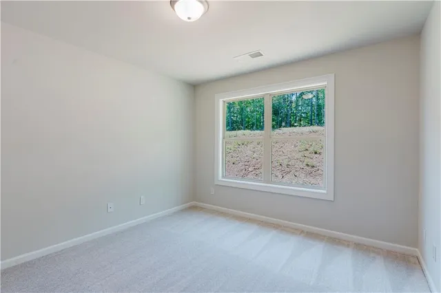 an empty room with wooden floor and a window