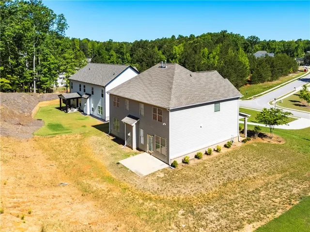 a view of a house with pool and sitting area