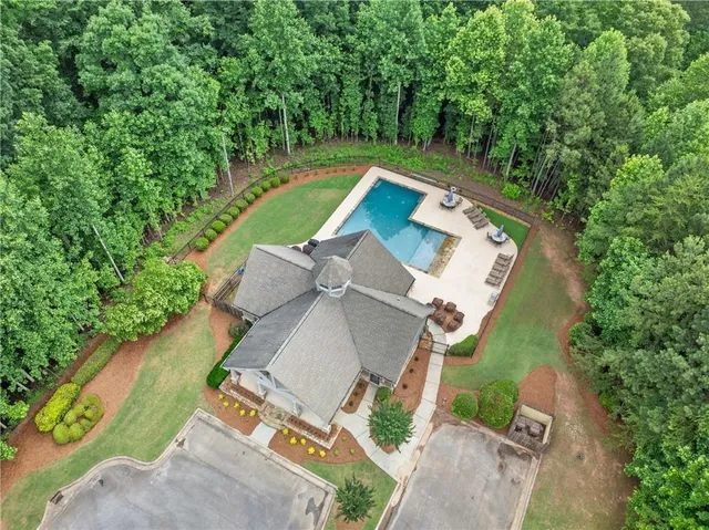 an aerial view of a house with a yard