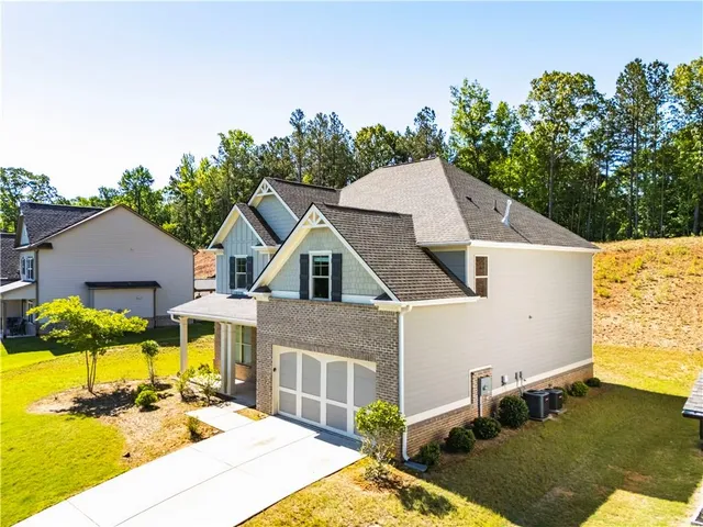 a view of a white house with a yard