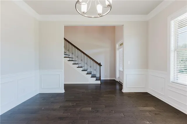 a view of entryway and hall with wooden floor