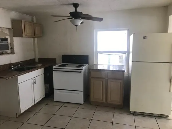 a kitchen with a refrigerator stove and cabinets