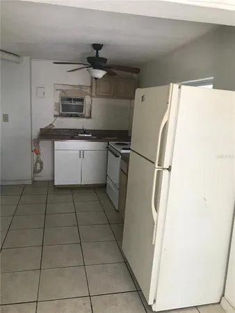 a kitchen with a refrigerator and a stove