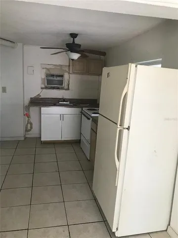 a kitchen with a refrigerator and a stove