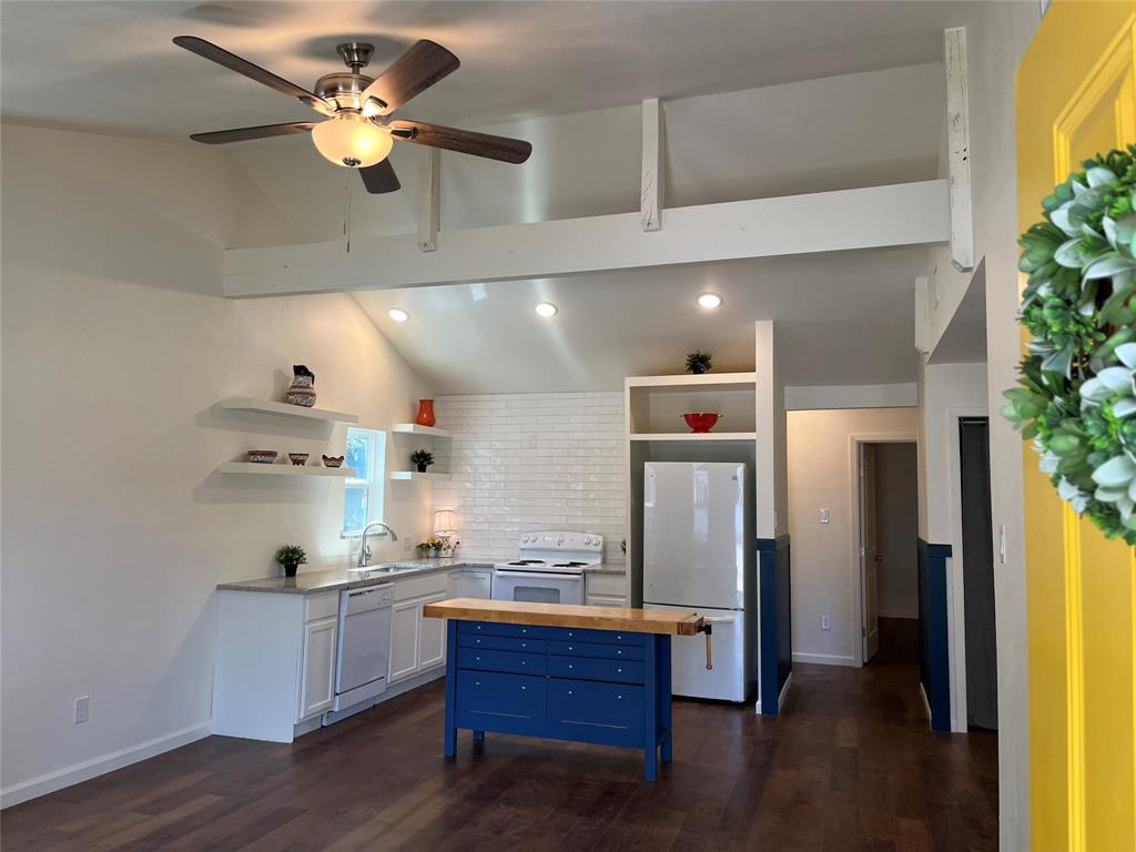 315 Hobson Street Weatherford, TX 76086 - Photo 1 of 24 a kitchen with stainless steel appliances granite countertop a refrigerator a sink dishwasher a stove and a dining table with wooden floor