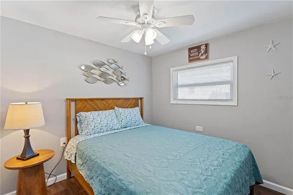a bedroom with a bed and a painting on the wall
