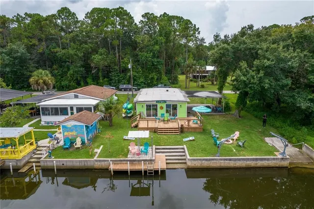 an aerial view of a house with swimming pool garden view and lake view