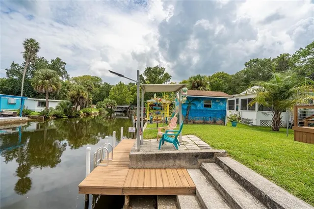 a view of a house with pool and a yard