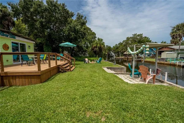 a view of a backyard with table and chairs under an umbrella