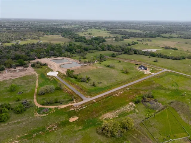 an aerial view of a golf course with houses
