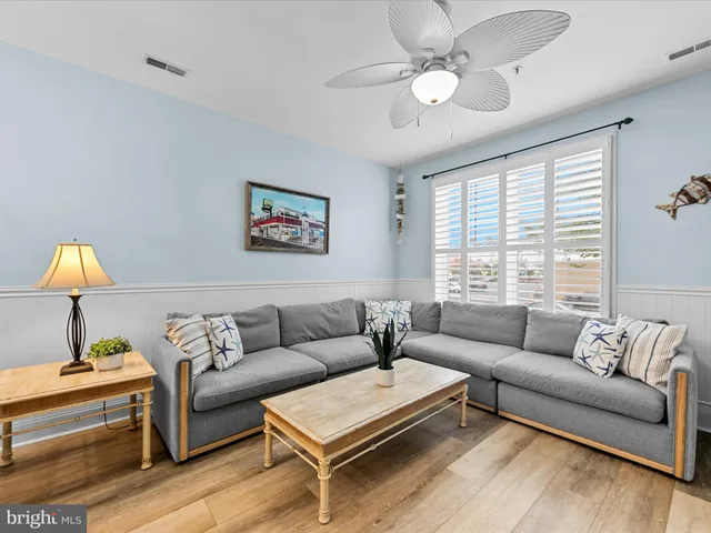 a living room with furniture a chandelier and a table