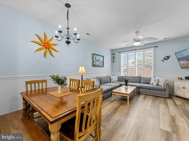 a living room with furniture a couch and a chandelier
