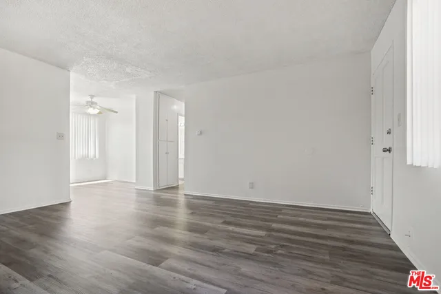 a view of an empty room and wooden floor