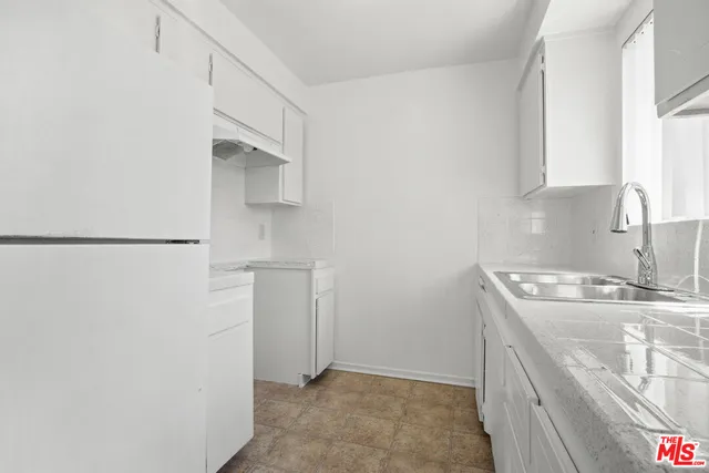 a utility room with cabinets washer and dryer