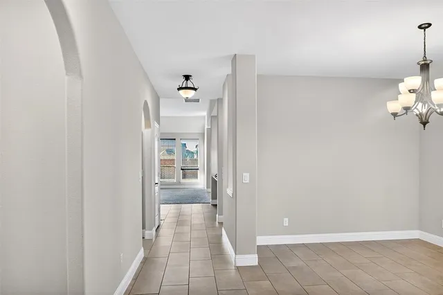 a view of a hallway with wooden shelves