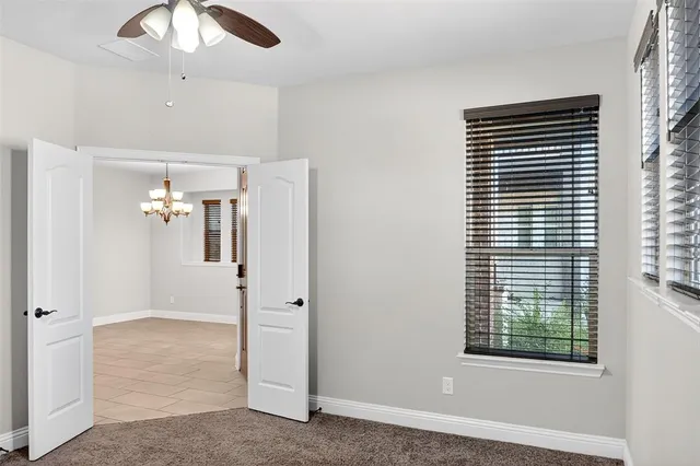 a view of a livingroom with a ceiling fan and window