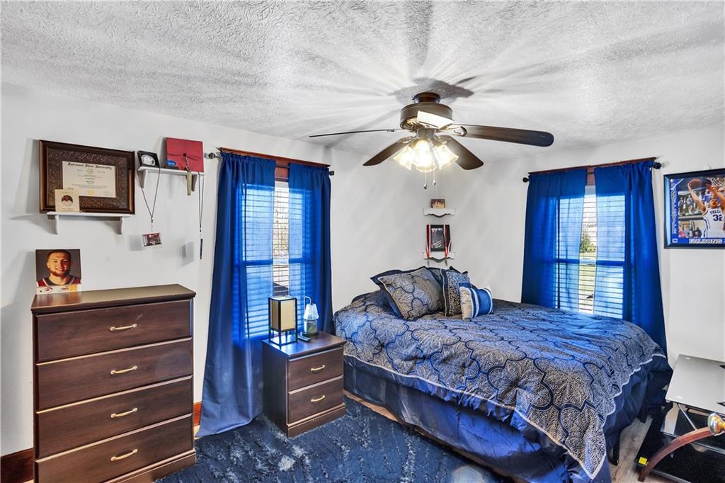 804 George Street Scottdale, PA 15683 - Photo 20 of 34 a bedroom with a bed and a chandelier