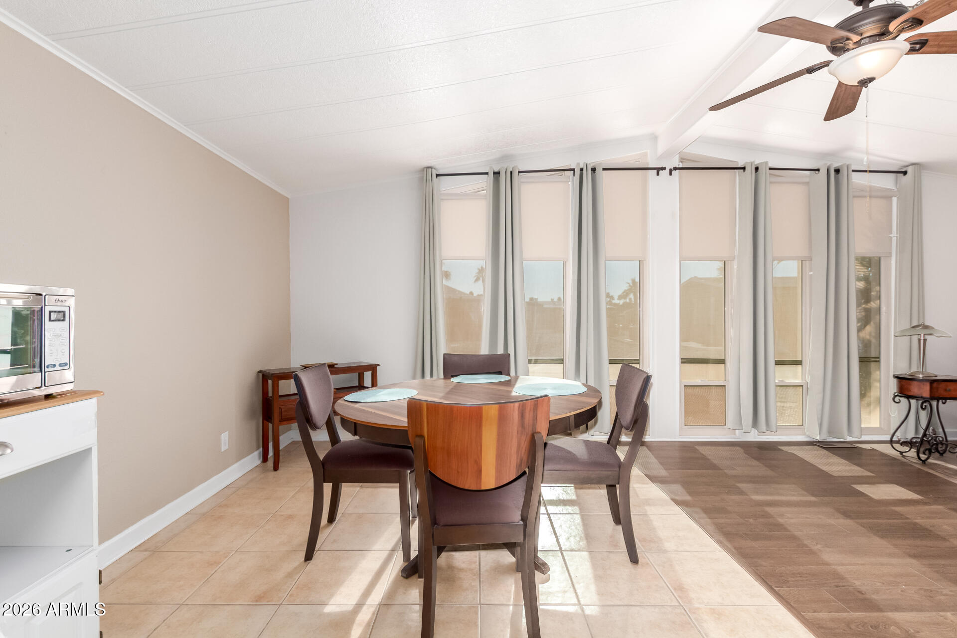 5402 East McKellips Road, Unit 186 Mesa, AZ 85215 - Photo 12 of 27 a dining room with furniture and large windows