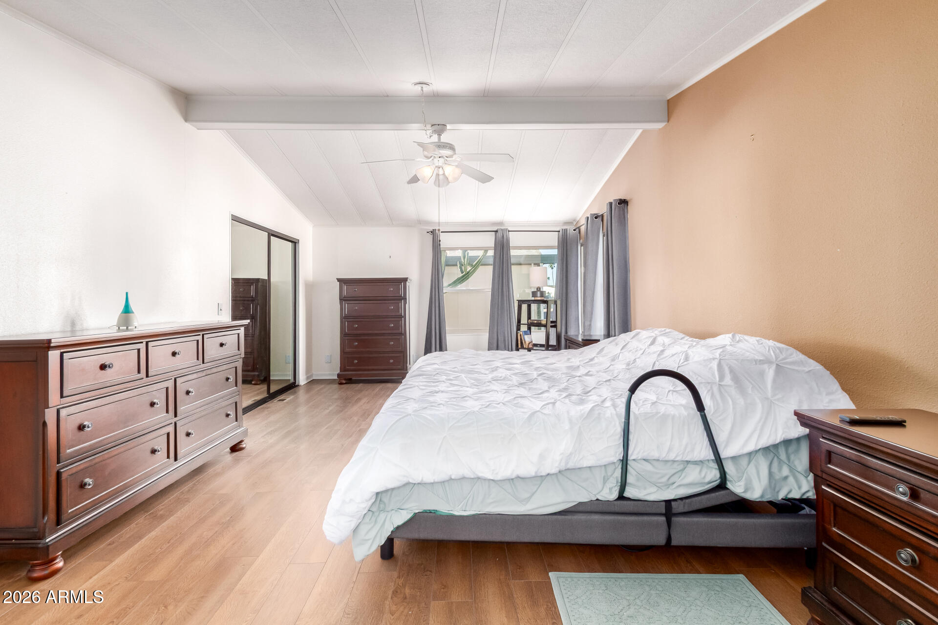 5402 East McKellips Road, Unit 186 Mesa, AZ 85215 - Photo 18 of 27 a spacious bedroom with a bed and a dresser