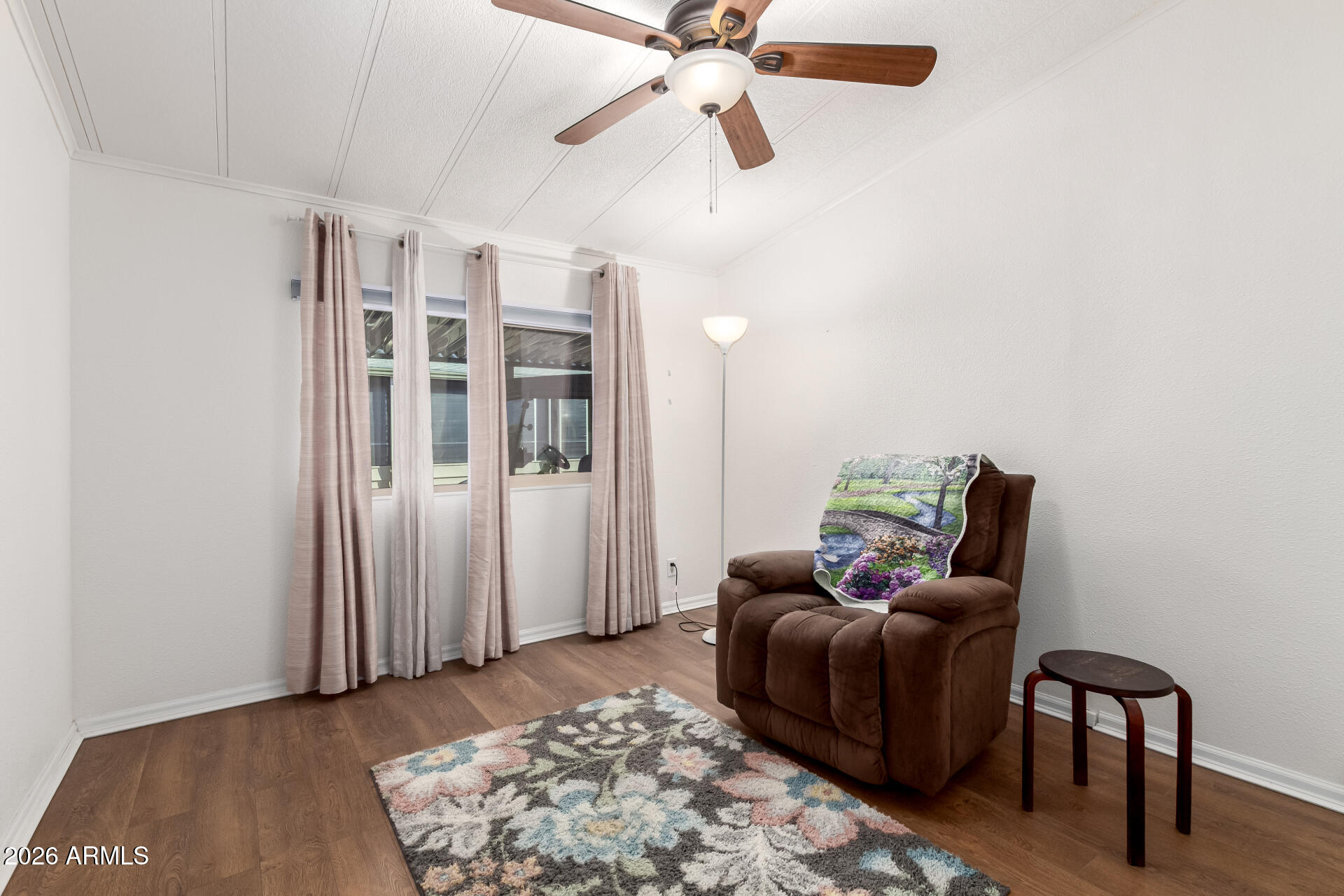 5402 East McKellips Road, Unit 186 Mesa, AZ 85215 - Photo 21 of 27 a living room with furniture and a rug