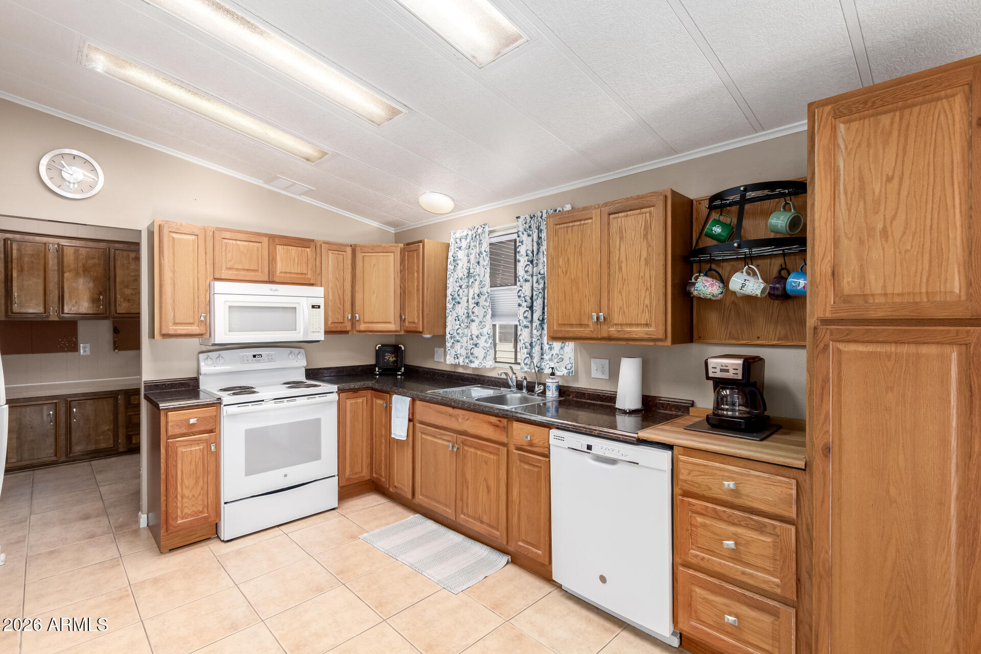 5402 East McKellips Road, Unit 186 Mesa, AZ 85215 - Photo 10 of 27 a kitchen with stainless steel appliances granite countertop a stove sink and cabinets