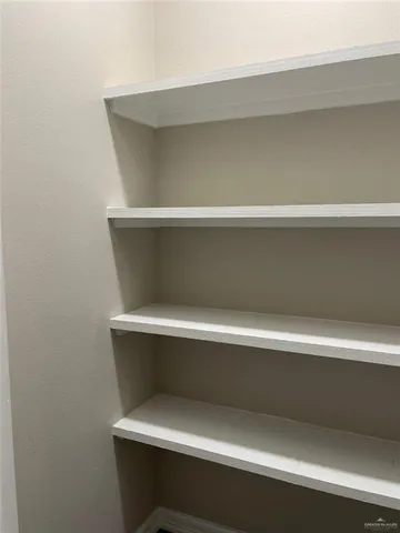 a view of a room with wooden floor and a sink