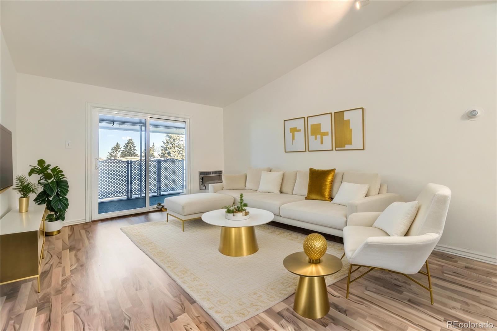735 South Clinton Street, Unit 5B Denver, CO 80247 - Photo 11 of 15 a living room with furniture and wooden floor