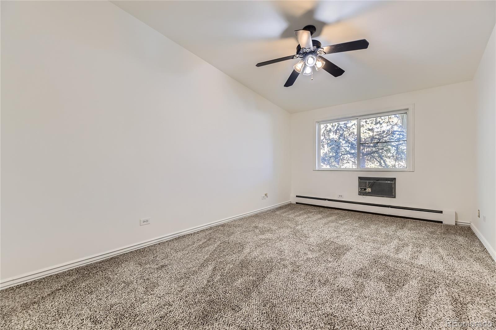 735 South Clinton Street, Unit 5B Denver, CO 80247 - Photo 6 of 15 an empty room with windows and fan