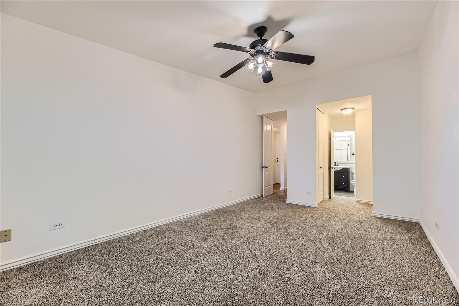 735 South Clinton Street, Unit 5B Denver, CO 80247 - Photo 7 of 15 a view of an empty room with a chandelier fan