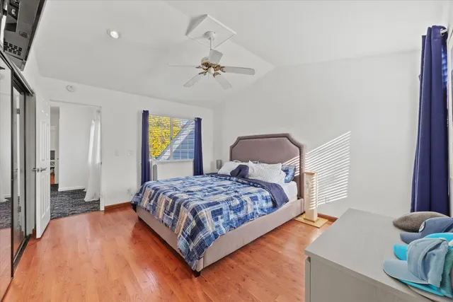 a bedroom with a bed and wooden floor