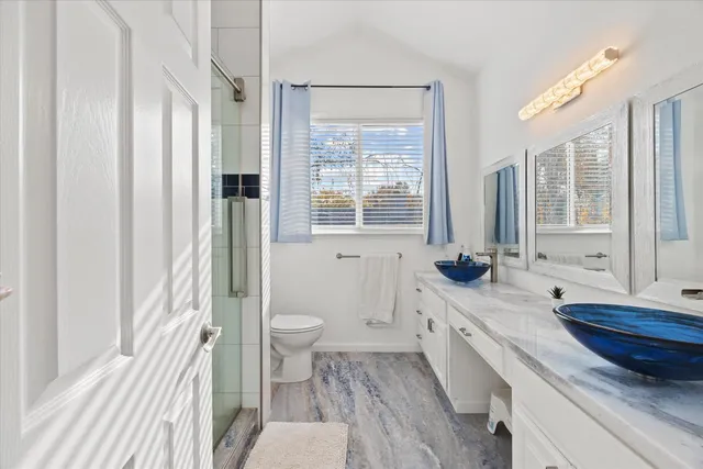 a bathroom with a granite countertop toilet a sink and a bathtub