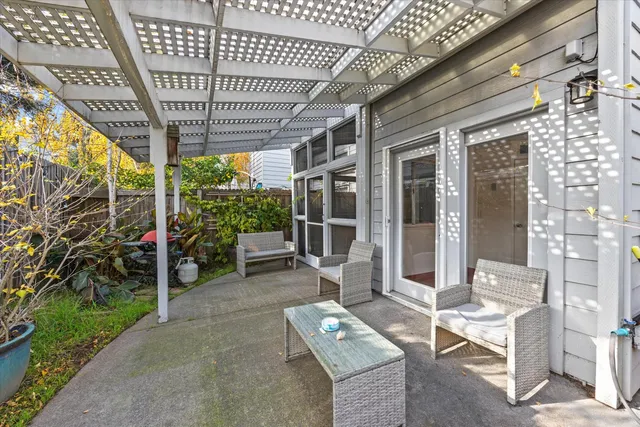 a view of a chairs and table in the patio with potted plants