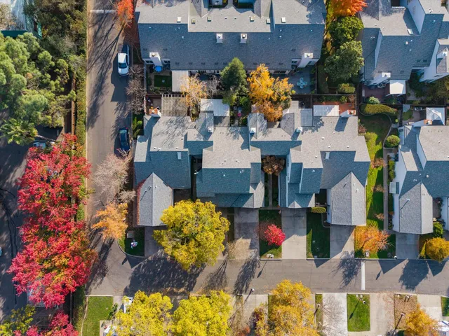 an aerial view of multiple houses with yard