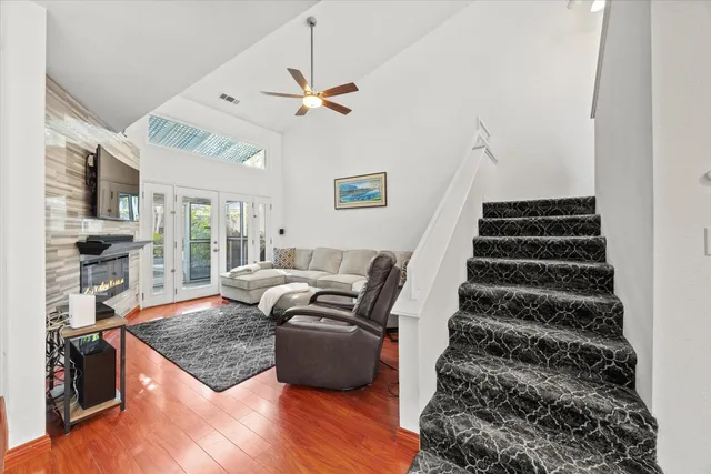 a living room with furniture and wooden floor